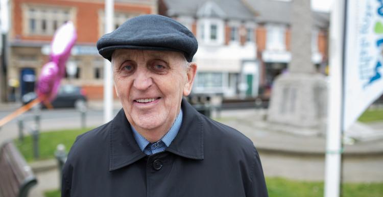 An elderly man wearing a hat smiling at the camera An elderly man wearing a hat smiling at the camera