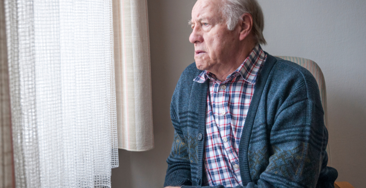 Man seated next to window