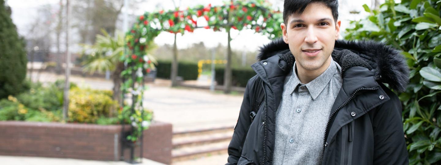 Young man outside looking at camera