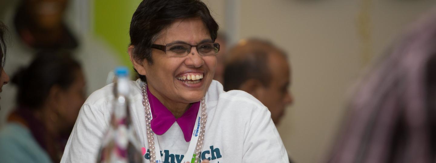 Woman smiling during healthwatch event